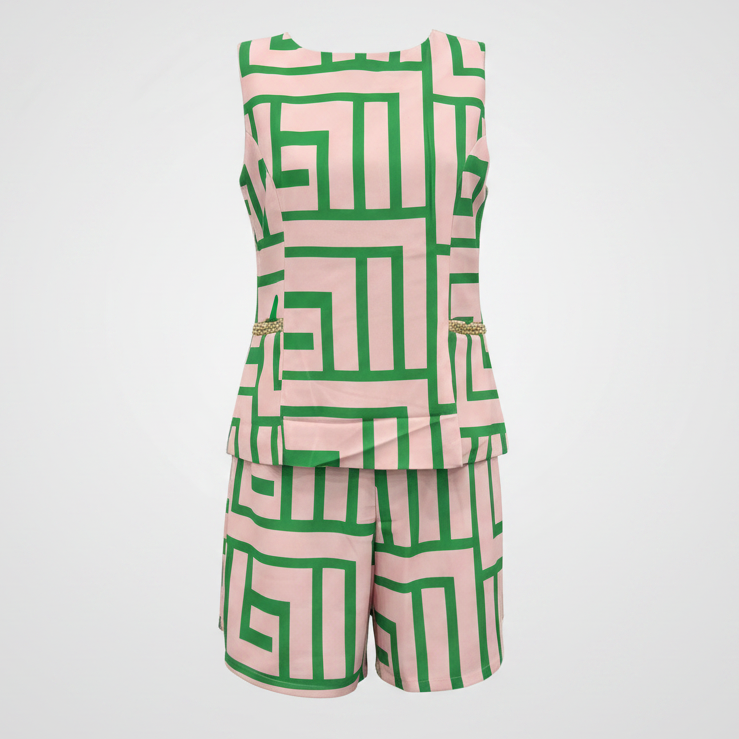 A sleeveless matching set consisting of a peplum top and shorts, featuring a bold green geometric maze-like pattern on a light pink background, displayed against a light gray gradient background.